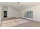 Well-lit living room with a ceiling fan, carpeted flooring, and a view of the entrance at 4221 Circleville St, North Port, FL 34286