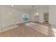 Bright living room with carpet, ceiling fan, and natural light from a large window at 4221 Circleville St, North Port, FL 34286