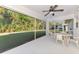 Screened patio with ceiling fan and view of lush backyard at 4221 Circleville St, North Port, FL 34286