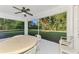 Enclosed patio with ceiling fan and view of lush backyard at 4221 Circleville St, North Port, FL 34286