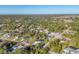 Wide aerial view of the residential area with houses surrounded by trees at 4501 Midland St, North Port, FL 34288