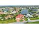 Beautiful waterfront home boasts a red tile roof, an attached two-car garage, and well-kept landscaping at 480 Macedonia Dr, Punta Gorda, FL 33950