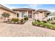 Home exterior featuring a brick driveway, arched windows, manicured landscaping and a red-tiled roof at 480 Macedonia Dr, Punta Gorda, FL 33950