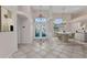Bright and airy foyer with decorative tile flooring, stained-glass doors, high ceilings, and a modern dining area at 480 Macedonia Dr, Punta Gorda, FL 33950
