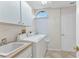 A bright laundry room with a sink, cabinets, and a washer/dryer at 480 Macedonia Dr, Punta Gorda, FL 33950