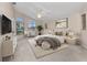 Bright main bedroom with a fan, large windows and neutral decor at 480 Macedonia Dr, Punta Gorda, FL 33950