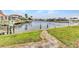 Beautiful waterfront property featuring lush green lawn, stone path, and stunning canal views at 480 Macedonia Dr, Punta Gorda, FL 33950