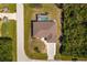 An aerial view shows the house, driveway, and screened in pool within property boundary lines at 7014 Baylor Street, Englewood, FL 34224