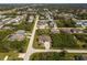 Aerial view of a home in a quiet neighborhood showcasing the home's screened pool at 7014 Baylor Street, Englewood, FL 34224