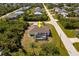 Charming single-story home with screened-in lanai and lush landscaping in quiet residential neighborhood from an aerial view at 7014 Baylor Street, Englewood, FL 34224