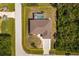 An aerial view shows the house, driveway, and screened in pool within property boundary lines at 7014 Baylor Street, Englewood, FL 34224