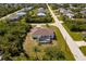 Charming single-story home with screened-in lanai and lush landscaping in quiet residential neighborhood from an aerial view at 7014 Baylor Street, Englewood, FL 34224