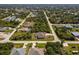 Charming single-story home with screened-in lanai and lush landscaping in quiet residential neighborhood from an aerial view at 7014 Baylor Street, Englewood, FL 34224