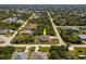 Charming single-story home with screened-in lanai and lush landscaping in quiet residential neighborhood from an aerial view at 7014 Baylor Street, Englewood, FL 34224