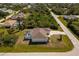 Single story home with a screened-in pool, mature trees, and well-manicured lawn in a residential neighborhood at 7014 Baylor Street, Englewood, FL 34224
