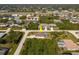 Aerial view of the home in a quiet neighborhood. The screened pool is visible in the backyard at 7014 Baylor Street, Englewood, FL 34224