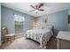 Comfortable bedroom featuring a ceiling fan, cozy carpet, and lots of natural light at 7014 Baylor Street, Englewood, FL 34224