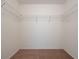 Spacious walk-in closet with carpeted flooring and wire shelving for organized storage at 7014 Baylor Street, Englewood, FL 34224