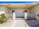 Inviting front porch with double doors, brick accents, and decorative plants at 7014 Baylor Street, Englewood, FL 34224