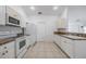 Well-equipped kitchen boasts white cabinetry, granite counters, and modern appliances for culinary enthusiasts at 7014 Baylor Street, Englewood, FL 34224