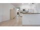 Bright kitchen featuring white cabinetry, granite countertops, and stainless steel appliances at 7014 Baylor Street, Englewood, FL 34224