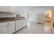 Well-appointed kitchen with white cabinets, granite counters, and modern appliances creating a stylish cooking space at 7014 Baylor Street, Englewood, FL 34224