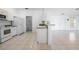 Well-lit kitchen featuring modern appliances, a breakfast bar and tiled flooring at 7014 Baylor Street, Englewood, FL 34224