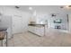 Bright and open kitchen featuring white cabinetry, tile flooring, and granite countertops, ideal for Gathering gatherings at 7014 Baylor Street, Englewood, FL 34224