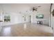 Large living room with modern ceiling fan, tile flooring, and sliding doors at 7014 Baylor Street, Englewood, FL 34224