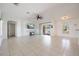Spacious living room with tile flooring, ceiling fan, and sliding glass doors leading to the outdoor at 7014 Baylor Street, Englewood, FL 34224