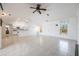 Airy living room with tile flooring and open layout, adjacent to the kitchen and dining areas at 7014 Baylor Street, Englewood, FL 34224