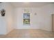 Living room space features tiled flooring, large window, and white paint at 7014 Baylor Street, Englewood, FL 34224
