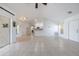 Expansive living room showcasing tile flooring, access to the kitchen, and natural light at 7014 Baylor Street, Englewood, FL 34224