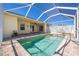 Inviting screened-in pool and spa featuring a brick paver deck and access to an outdoor patio at 7014 Baylor Street, Englewood, FL 34224