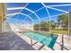 Inviting screened-in pool and spa featuring a brick paver deck and a serene outdoor living space at 7014 Baylor Street, Englewood, FL 34224
