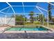 Relaxing screened-in lanai with a pool, brick flooring, and serene outdoor views at 7014 Baylor Street, Englewood, FL 34224