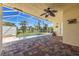 Inviting, screened-in lanai with a small pool, brick flooring, and an outdoor ceiling fan at 7014 Baylor Street, Englewood, FL 34224