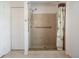 Accessible shower with grab bars, tile surround, and a decorative shower curtain at 7014 Baylor Street, Englewood, FL 34224