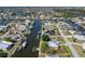 Beautiful aerial view of canal-front home with boat dock and lift in a waterfront community at 721 Dania Ct, Punta Gorda, FL 33950