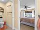 Bathroom with adjacent bedroom showcases a toilet and nautical themed decor at 721 Dania Ct, Punta Gorda, FL 33950