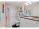 Bathroom features world map shower curtain, single vanity, tub and shower combo at 721 Dania Ct, Punta Gorda, FL 33950