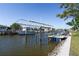 View of a private boat dock with a boat lift, providing direct access to the water at 721 Dania Ct, Punta Gorda, FL 33950