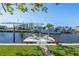Backyard canal view featuring boat dock with boat lift and chairs for enjoying waterfront living at 721 Dania Ct, Punta Gorda, FL 33950