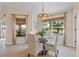 Bright dining room with a glass-top table, comfortable seating, and scenic canal views at 721 Dania Ct, Punta Gorda, FL 33950