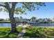 Waterfront property featuring a private dock with chairs, perfect for enjoying water activities and serene views at 721 Dania Ct, Punta Gorda, FL 33950