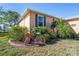 Charming home exterior enhanced by colorful landscaping and a decorative bicycle, adding to its curb appeal at 721 Dania Ct, Punta Gorda, FL 33950