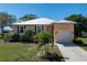 Inviting front exterior with lush landscaping, palm trees, and a well-lit driveway at 721 Dania Ct, Punta Gorda, FL 33950