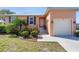 Close up front exterior featuring a well maintained yard, walkway, and attached garage at 721 Dania Ct, Punta Gorda, FL 33950