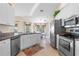 Bright kitchen offering stainless steel appliances, white cabinetry, and a view of the adjacent dining area at 721 Dania Ct, Punta Gorda, FL 33950