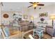 Comfortable living room with neutral tones, ceiling fan, and decor, flowing into the kitchen area at 721 Dania Ct, Punta Gorda, FL 33950